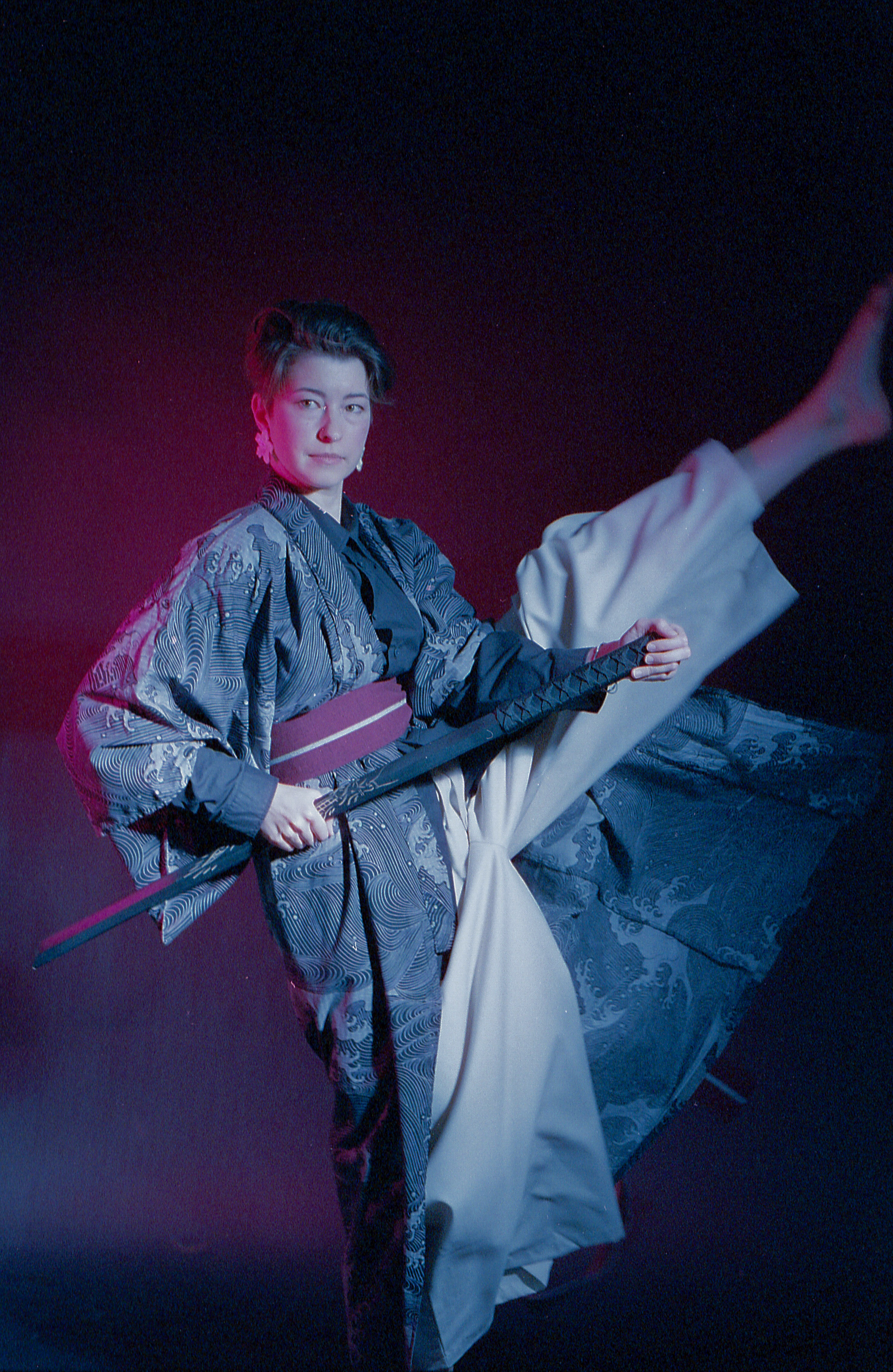 Yulia in a kimono raising the scabbard, magenta and blue light